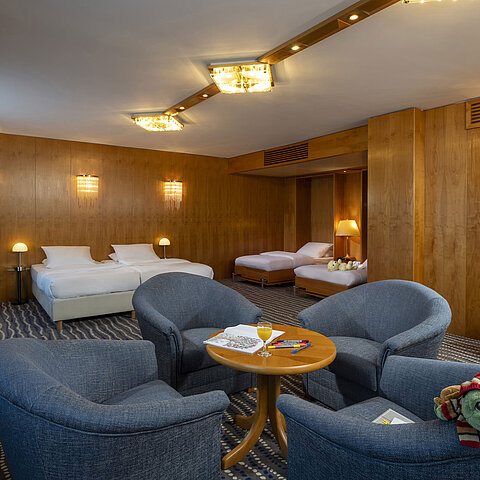 Spacious Superior Family Room at the Maritim Hotel Magdeburg with two double beds, seating area, and child-friendly details.