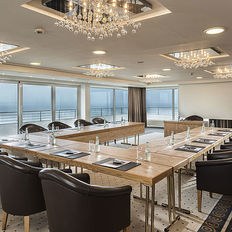 Salon Hamburg au Maritim Seehotel Timmendorfer Strand, salle de réunion avec vue mer, table en L et éclairage élégant.